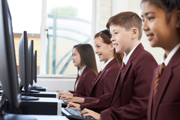 group of students working on computers in a classroom
