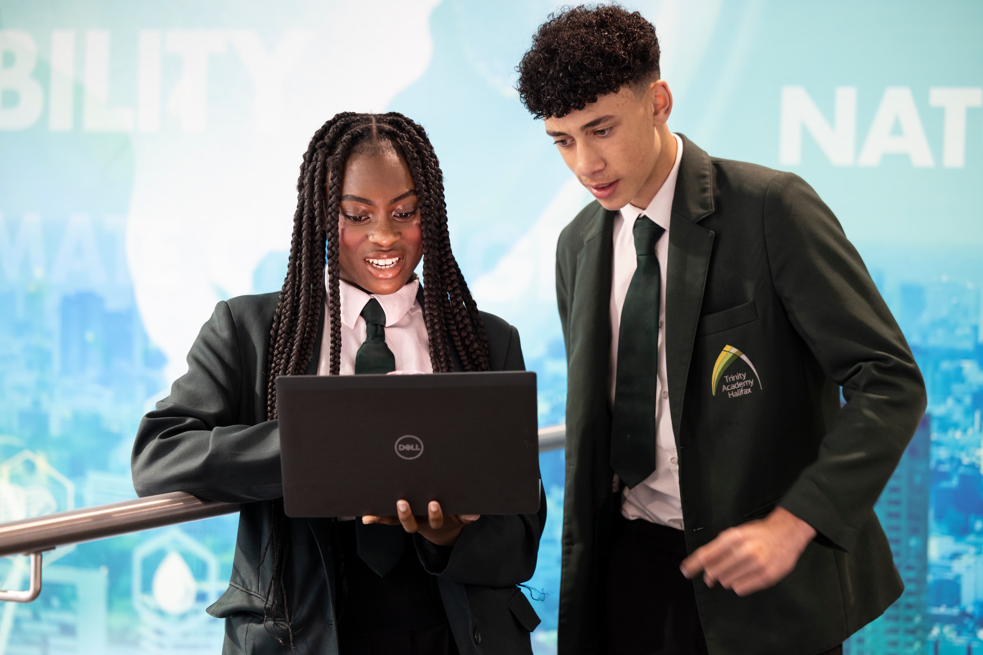 Two students looking at a laptop